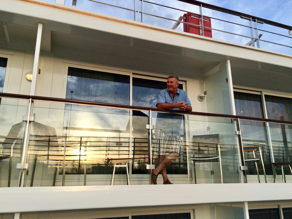 Man on Viking river cruise ship balcony.