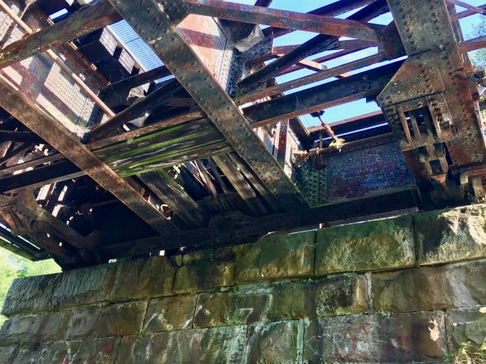 view from below a rusty trestle