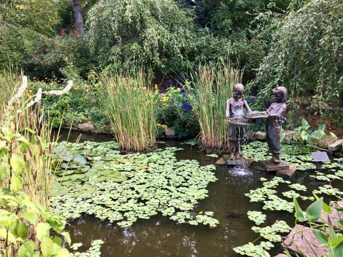 garden pond with statue of children