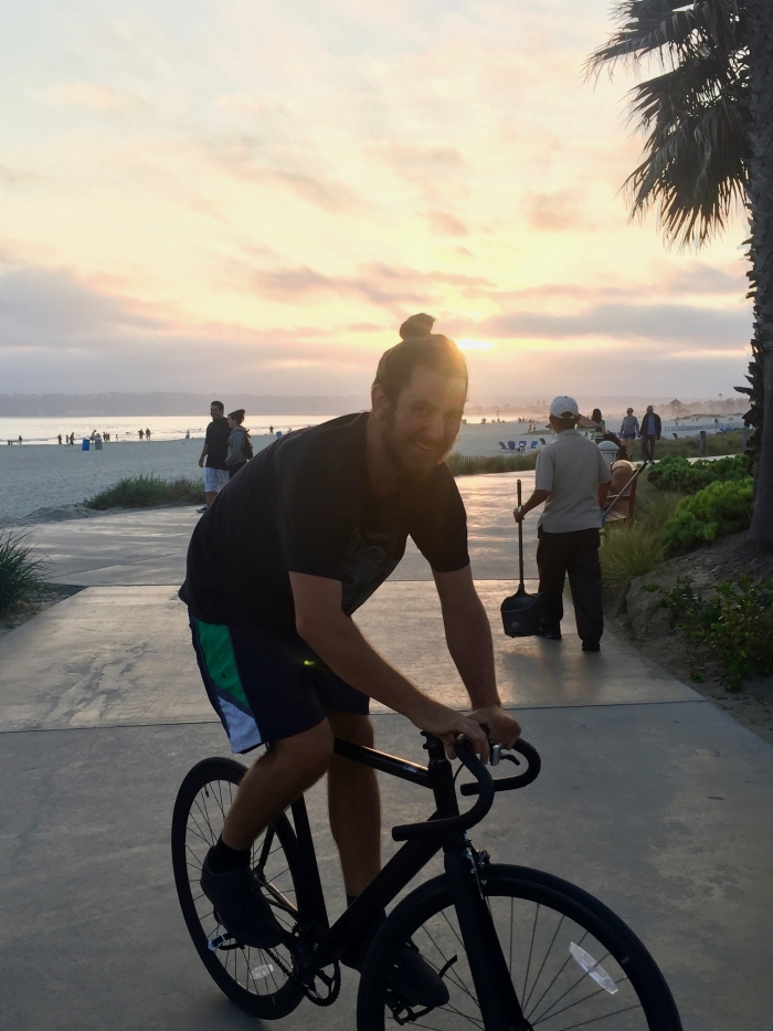 Man riding a bicycle at sunset