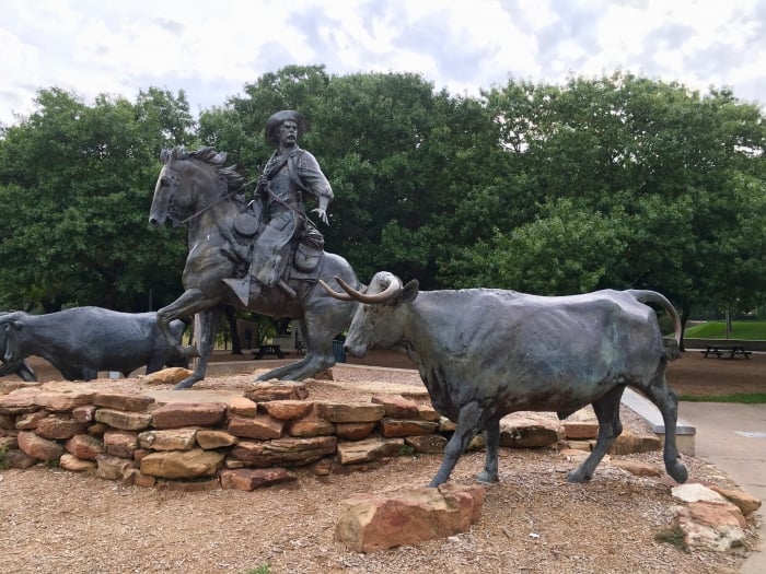 cowboy and steers statues
