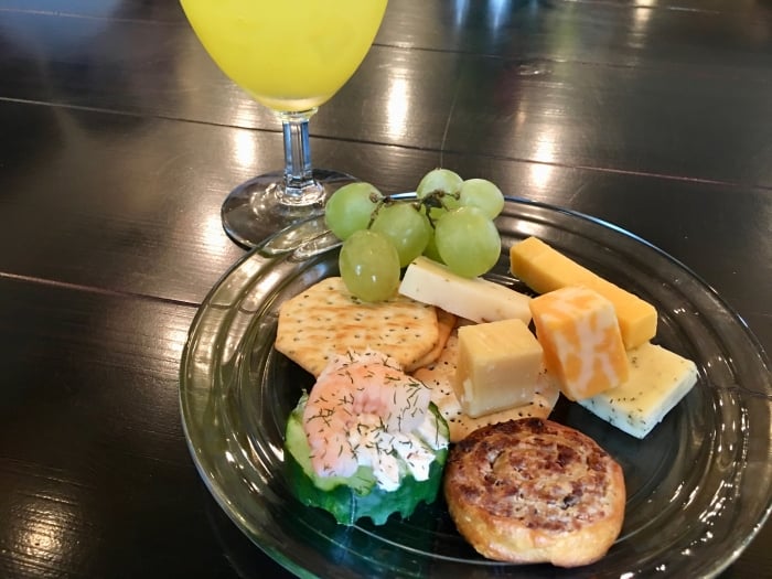 plate of cheese, crackers, grapes, and finger food