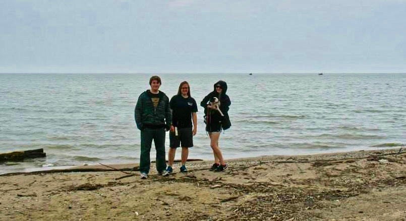 Three people standing beside Lake Erie.