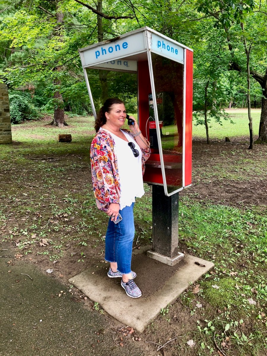 woman using telephone booth